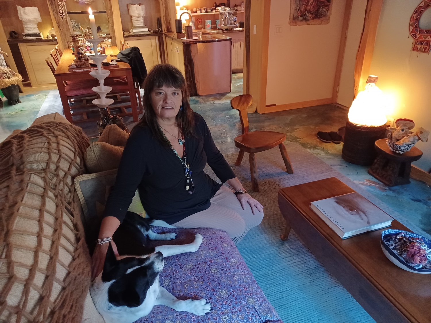 Stacy Cushman’s entire condominium is an art gallery. Even the floor is a work of art. The lamp and candle holder are her own creations, while pieces collected from all over the world fill every available space.